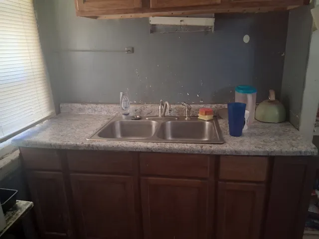 a view of a hallway with workspace and wooden floor