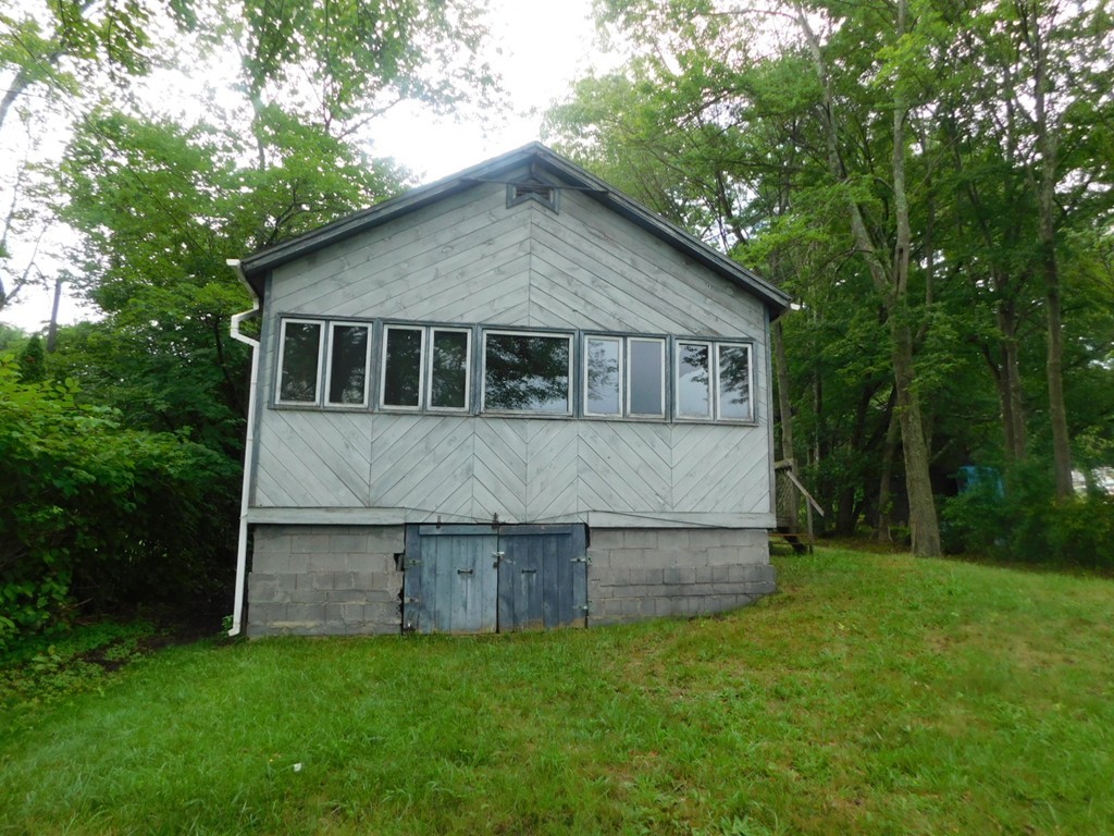 74 Union Road Wales, MA 01081 - Photo 2 of 14 a front view of house with yard and trees in the background