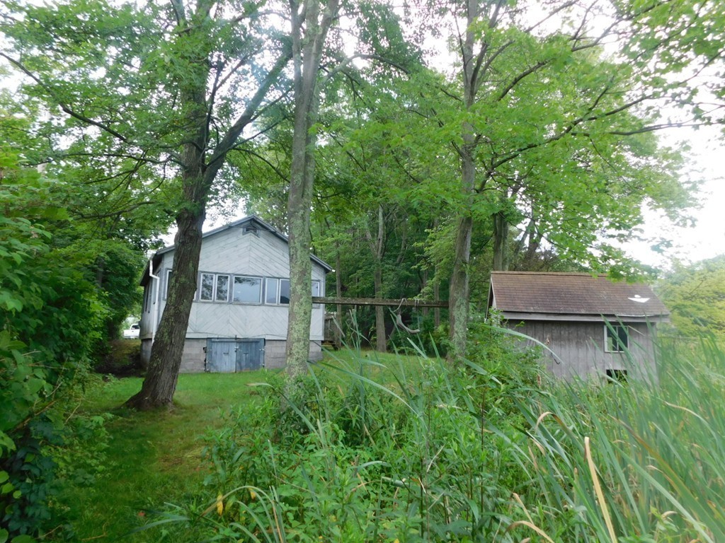 74 Union Road Wales, MA 01081 - Photo 4 of 14 a backyard of a house with lots of green space