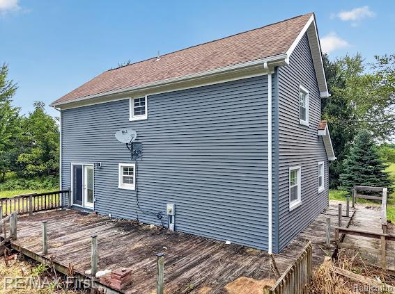 56375 Bates Road New Baltimore, MI 48051 - Photo 5 of 35 Two-story exterior with horizontal siding, brown shingle roofing, and white-framed windows