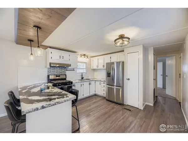 a kitchen with stainless steel appliances a stove refrigerator sink and microwave