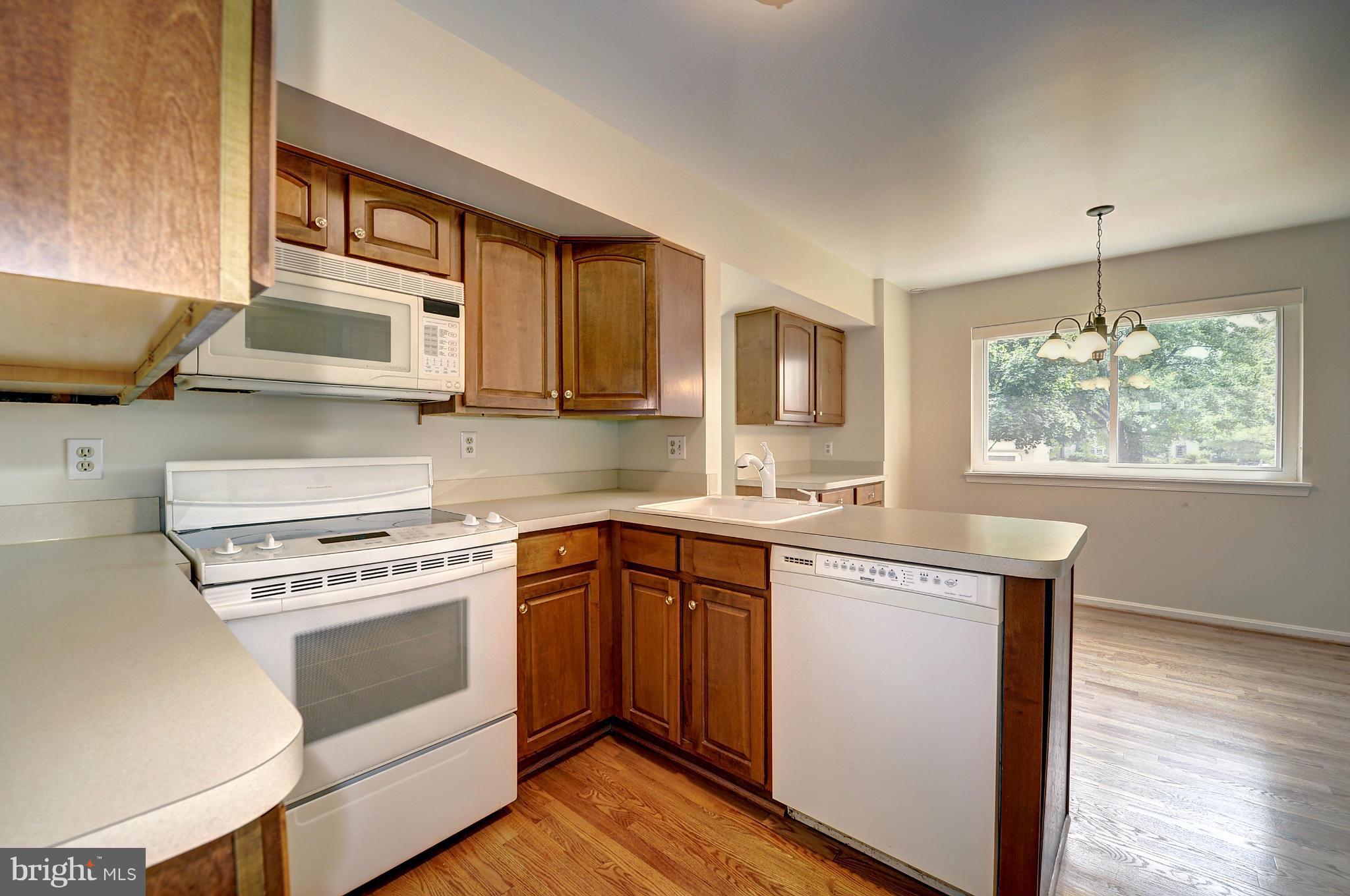 4320 Cub Run Road Chantilly, VA 20151 - Photo 11 of 30 a kitchen with stainless steel appliances granite countertop a stove a sink and a microwave