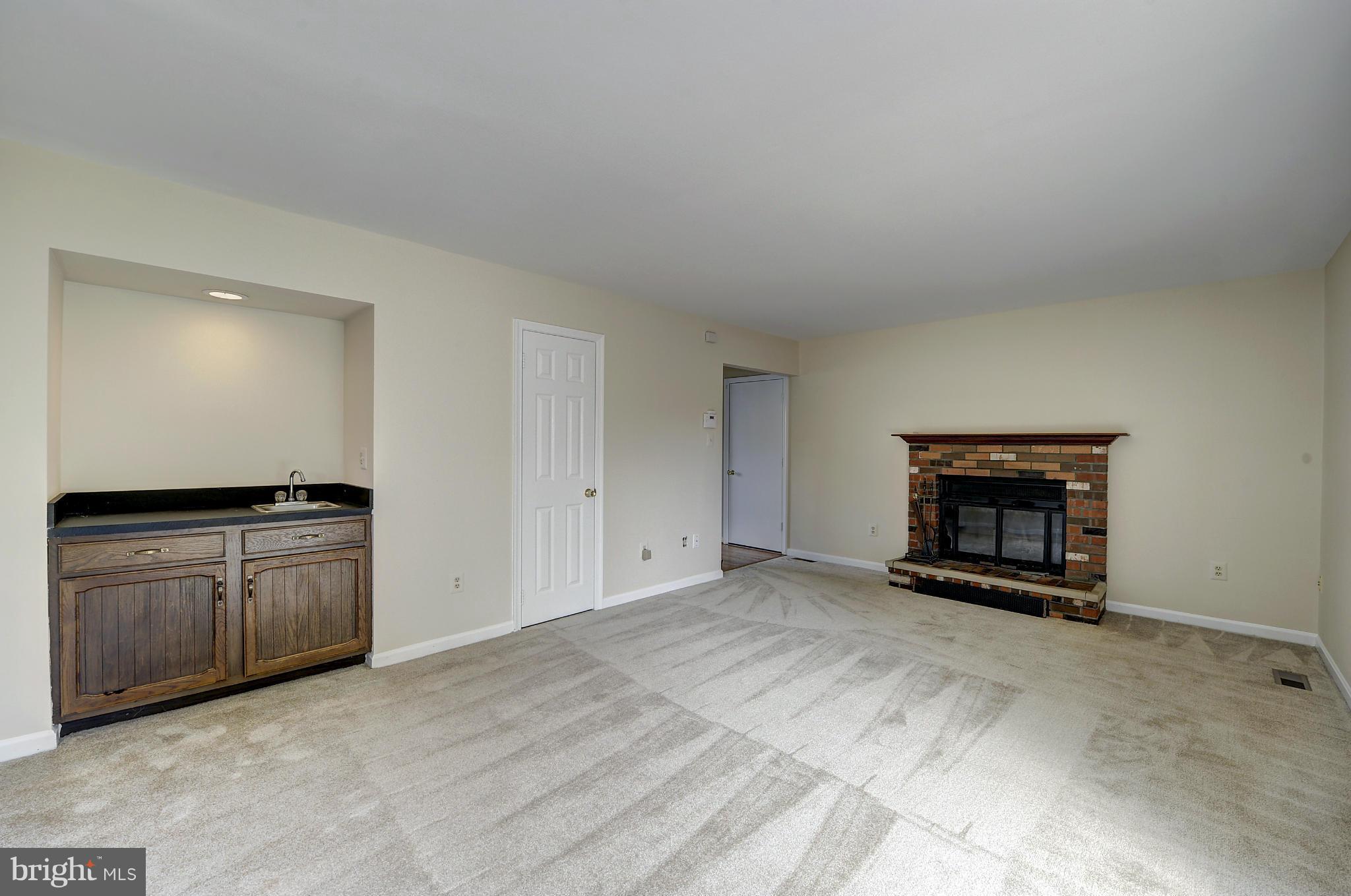 4320 Cub Run Road Chantilly, VA 20151 - Photo 13 of 30 a view of an empty room with a fireplace and a window