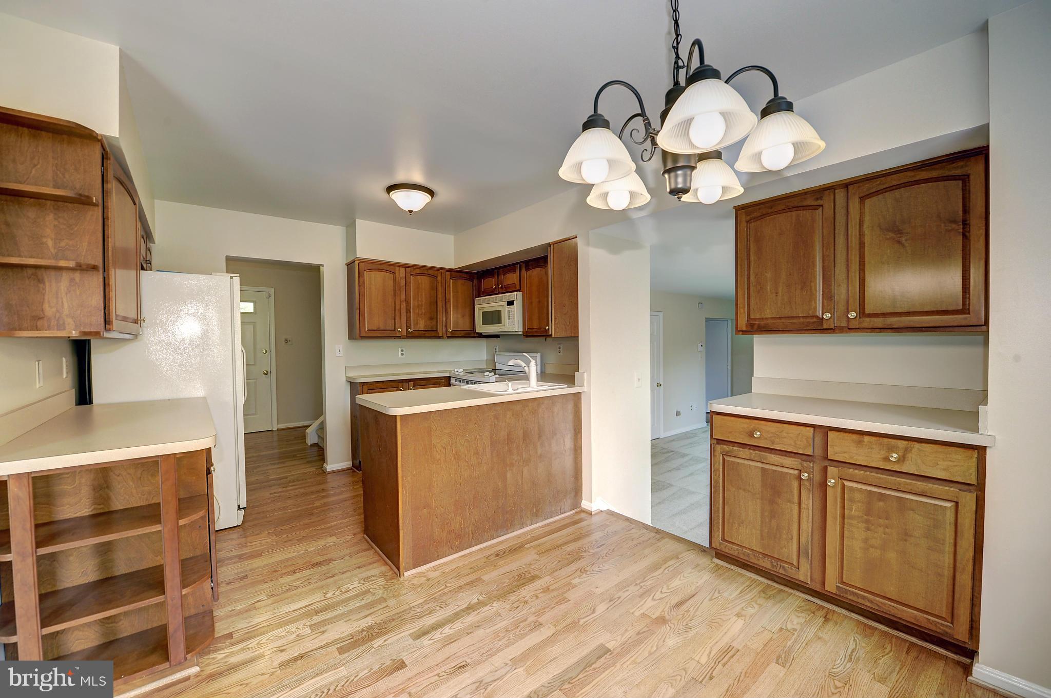 4320 Cub Run Road Chantilly, VA 20151 - Photo 9 of 30 a kitchen with a refrigerator chandelier and stove
