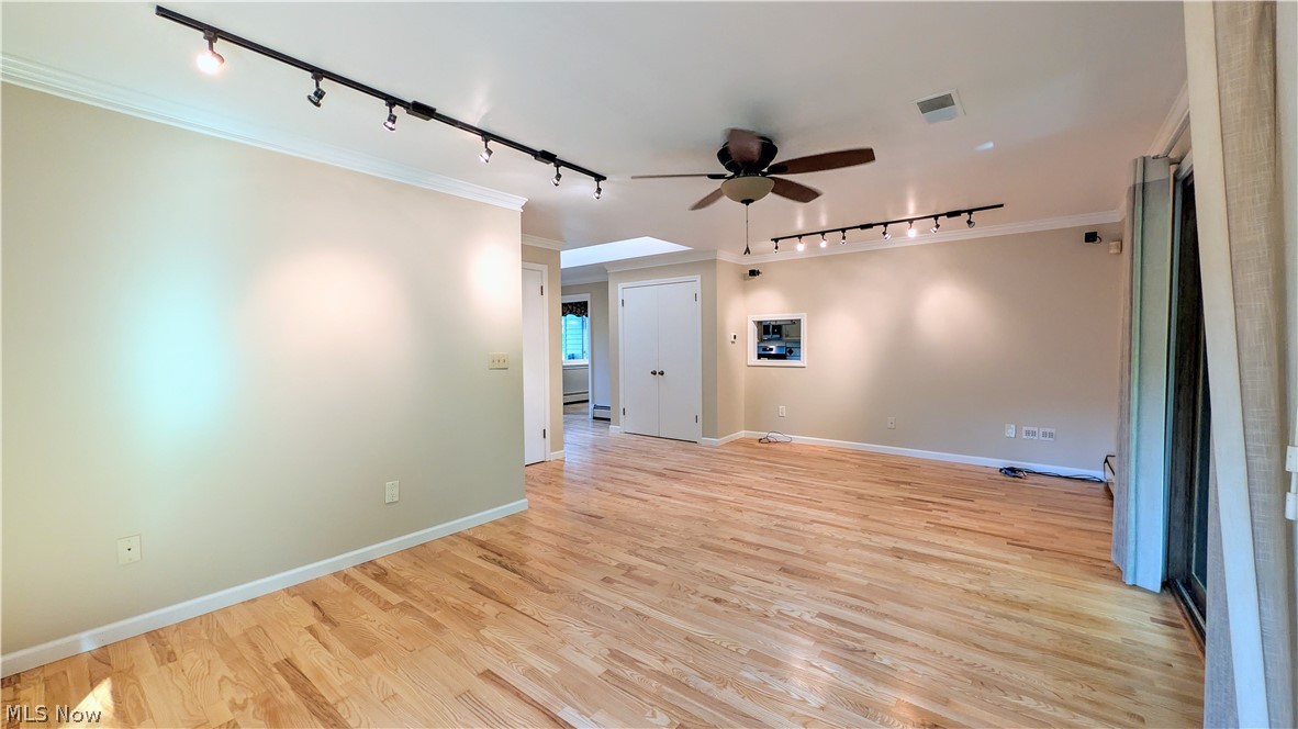 6409 Old Woods Road Ashtabula, OH 44004 - Photo 12 of 43 Spacious room featuring wood-finish flooring, track lighting, and a ceiling fan