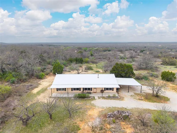 an aerial view of a house with a yard