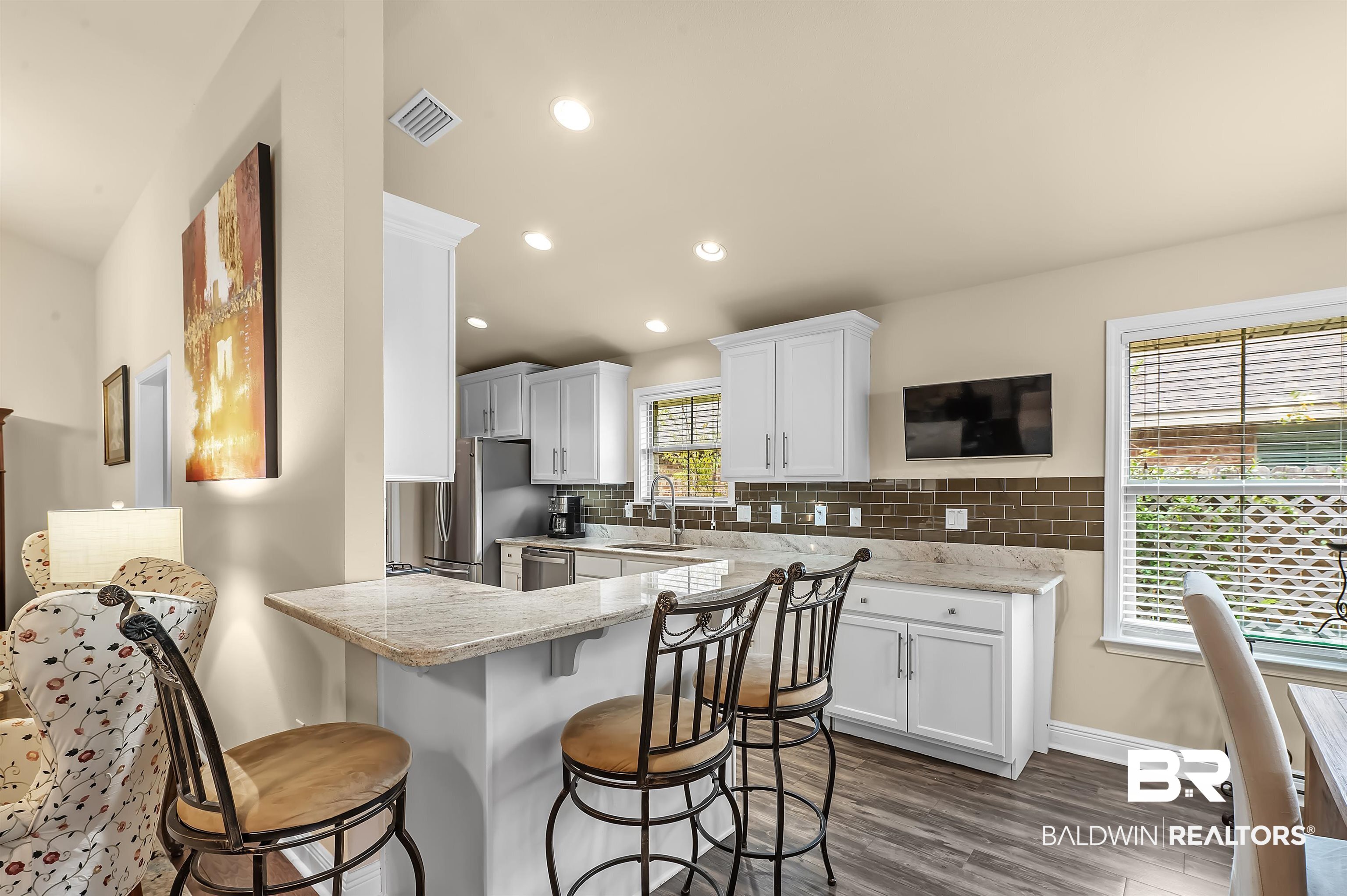 8896 Allay Lane Foley, AL 36535 - Photo 27 of 57 Kitchen with appliances with stainless steel finishes, sink, a wealth of natural light, and white cabinets