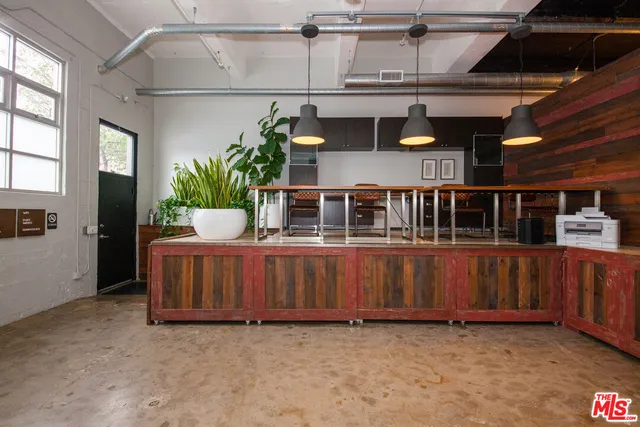 a view of room with a potted plant on a counter and a window