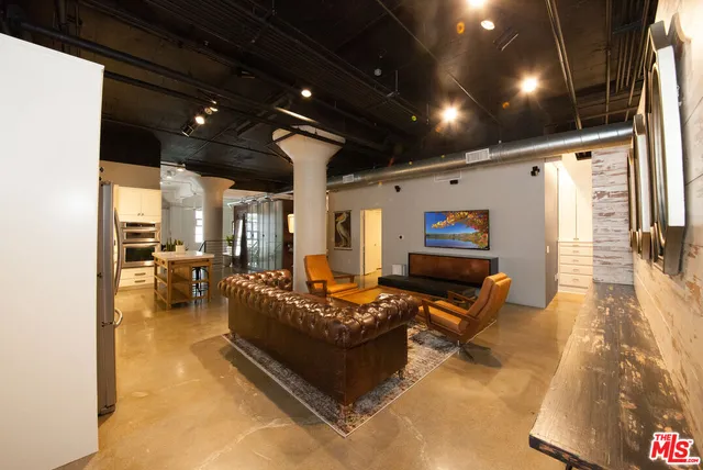 a kitchen with refrigerator and cabinets