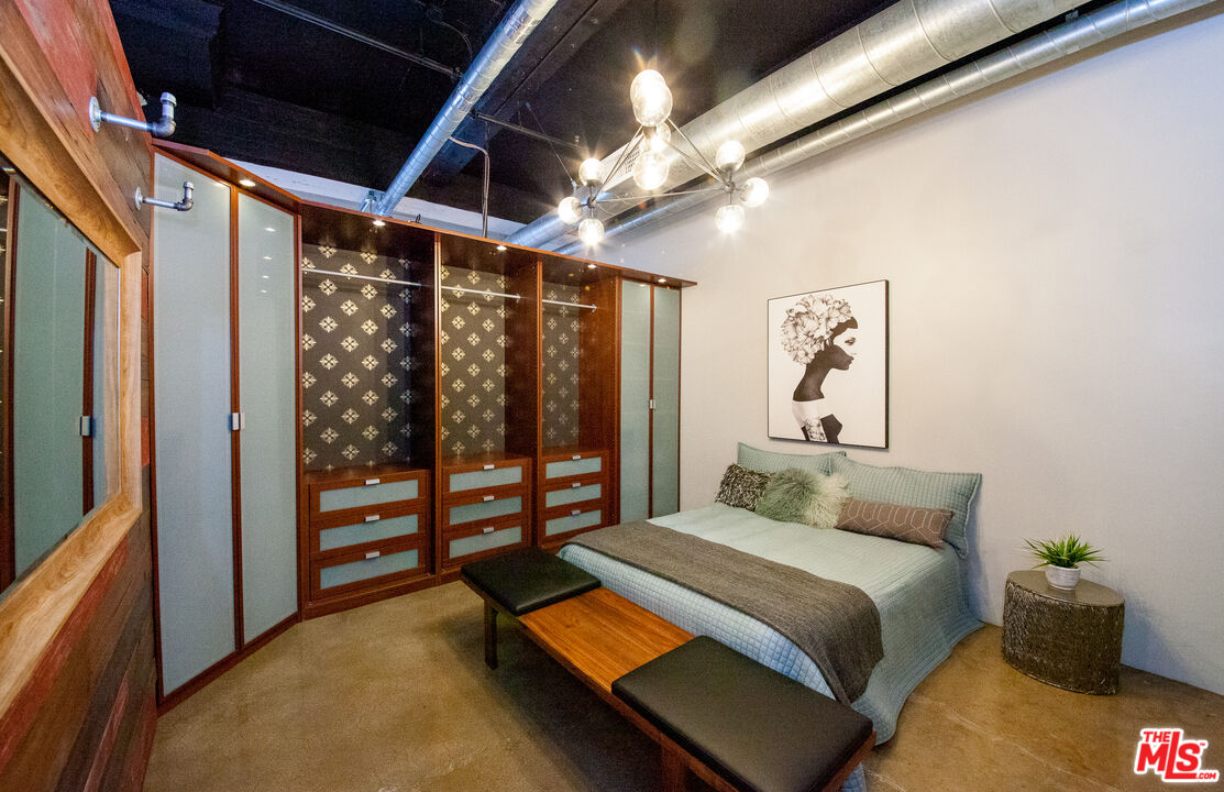 530 Molino Street, Unit 113 Los Angeles, CA 90013 - Photo 7 of 16 a bedroom with a bed next to a window