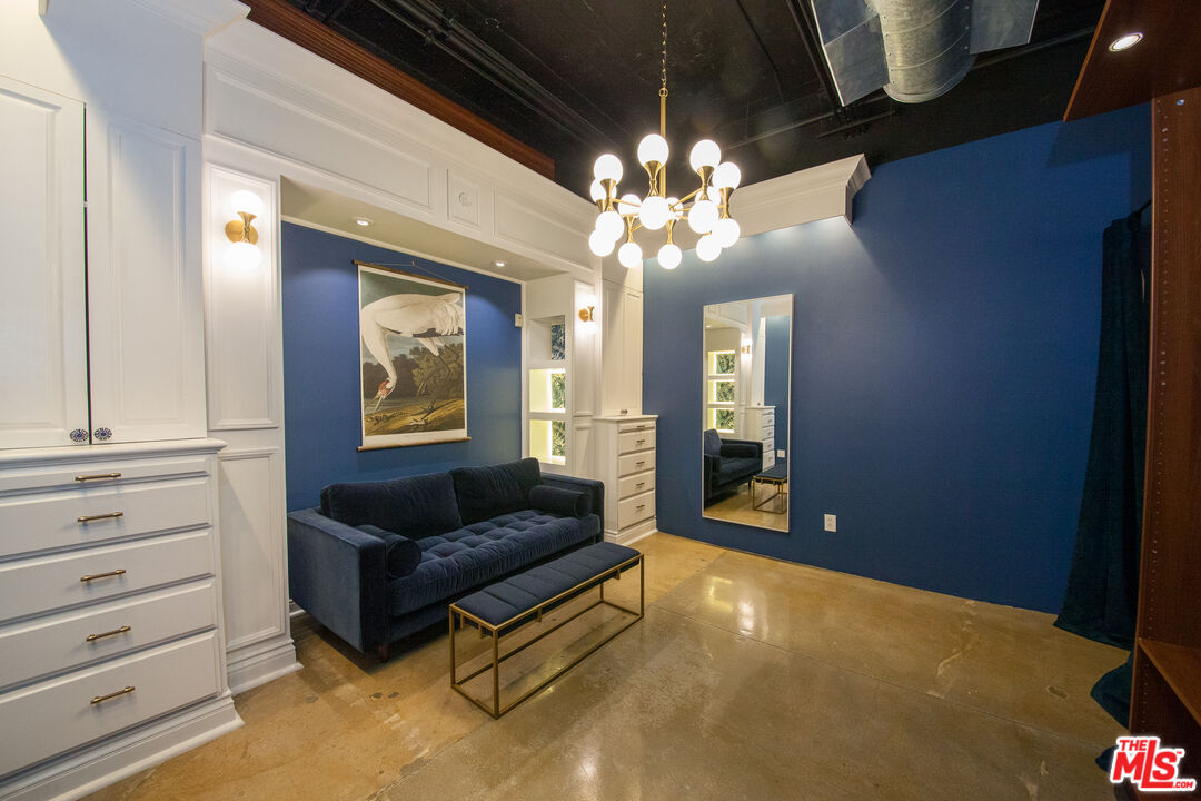 530 Molino Street, Unit 113 Los Angeles, CA 90013 - Photo 8 of 16 a living room with furniture and a chandelier