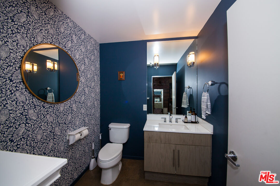 530 Molino Street, Unit 113 Los Angeles, CA 90013 - Photo 10 of 16 a bathroom with a toilet sink and mirror