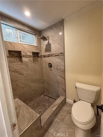 a bathroom with a toilet and a shower