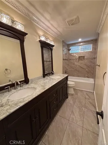 a bathroom with a granite countertop sink a mirror and a bathtub