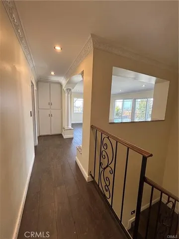 a view of a hallway with wooden floor