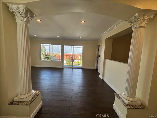 a view of a livingroom with wooden floor and a floor to ceiling window