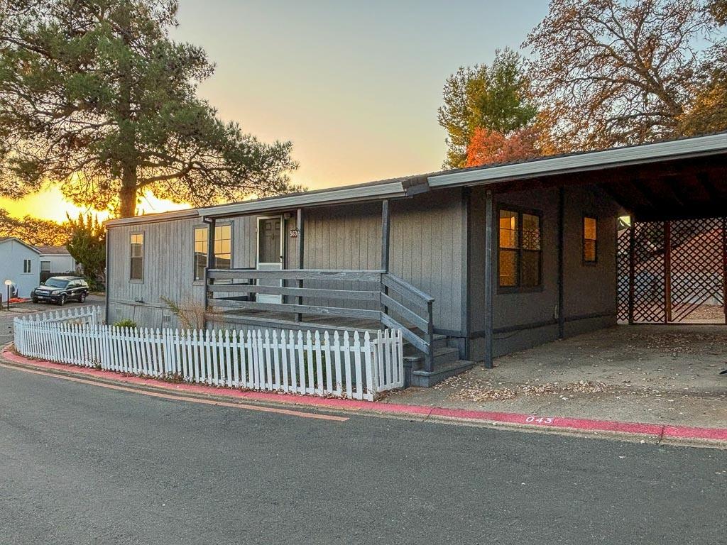 5635 Cody Drive Ione, CA 95640 - Photo 1 of 1 a view of a house with a small yard and wooden fence