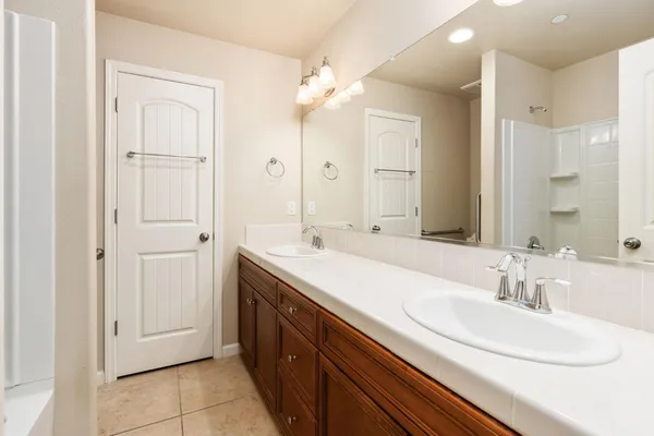 a bathroom with a double vanity sink mirror and