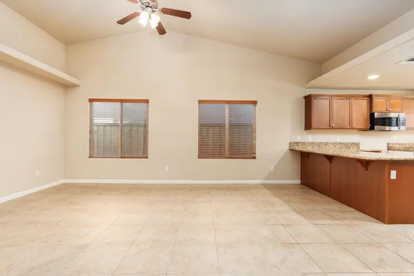a view of kitchen with granite countertop cabinets and a sink