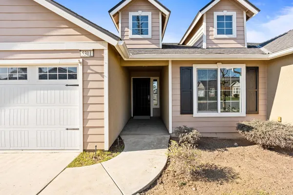 a view of a house with large windows