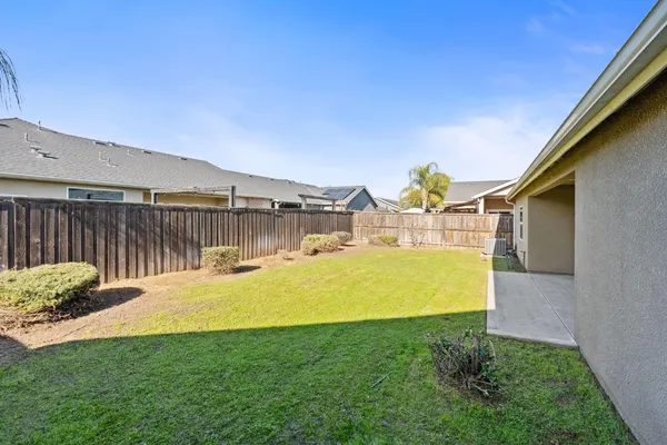 a swimming pool with outdoor seating and yard