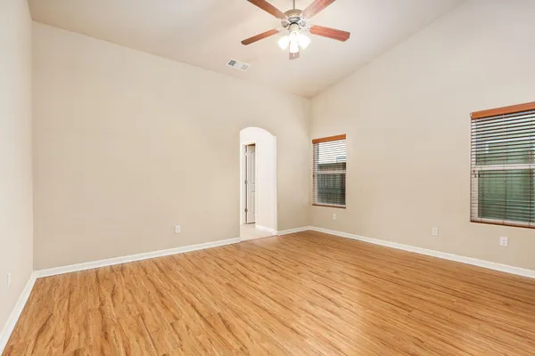 a view of a room with wooden floor and windows