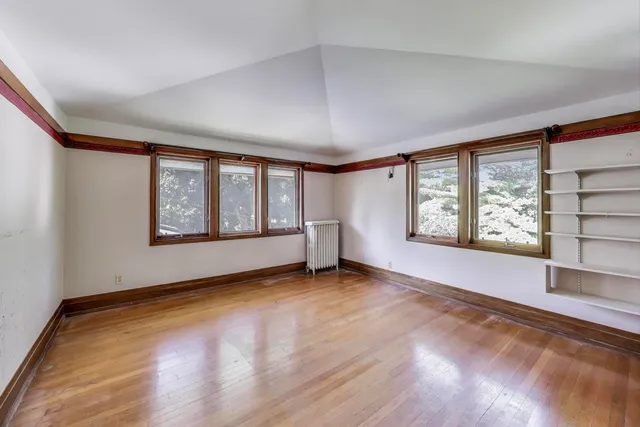 wooden floor in an empty room with a window