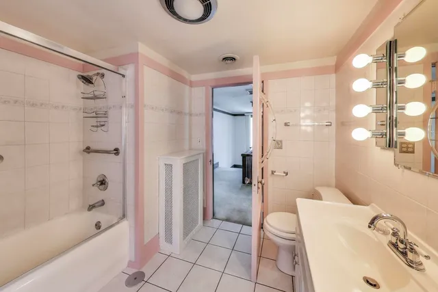 a bathroom with a bathtub shower sink and toilet