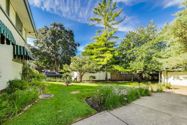 a front view of house with yard and trees