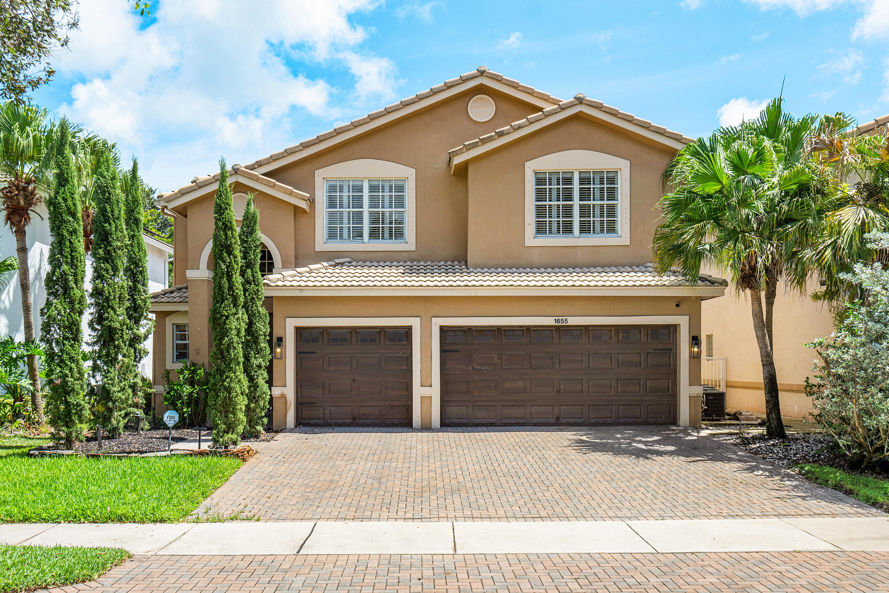 a front view of a house with a yard and garage