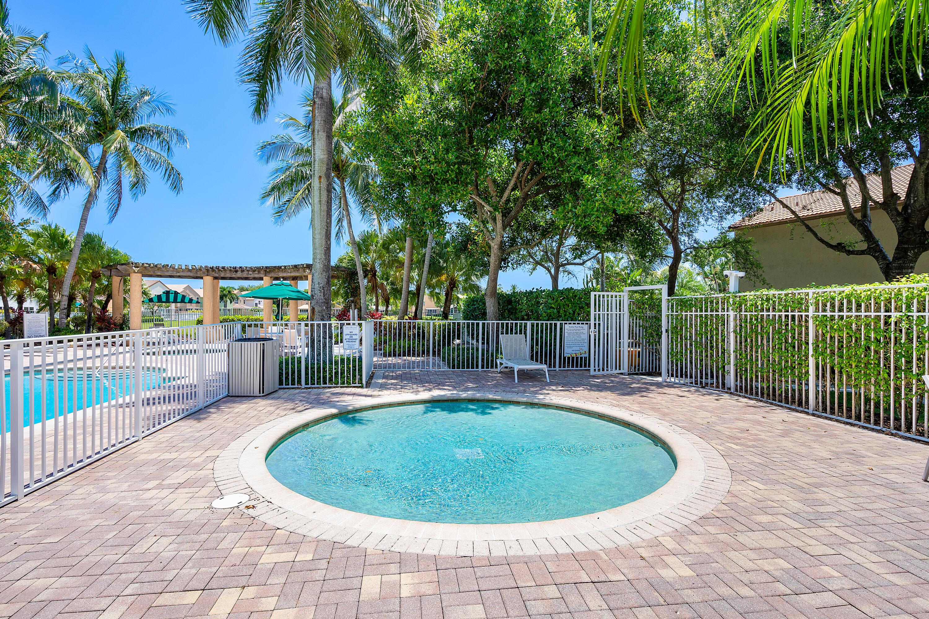 1655 East Classical Boulevard Delray Beach, FL 33445 - Photo 37 of 40 a view of a swimming pool with a patio and a garden