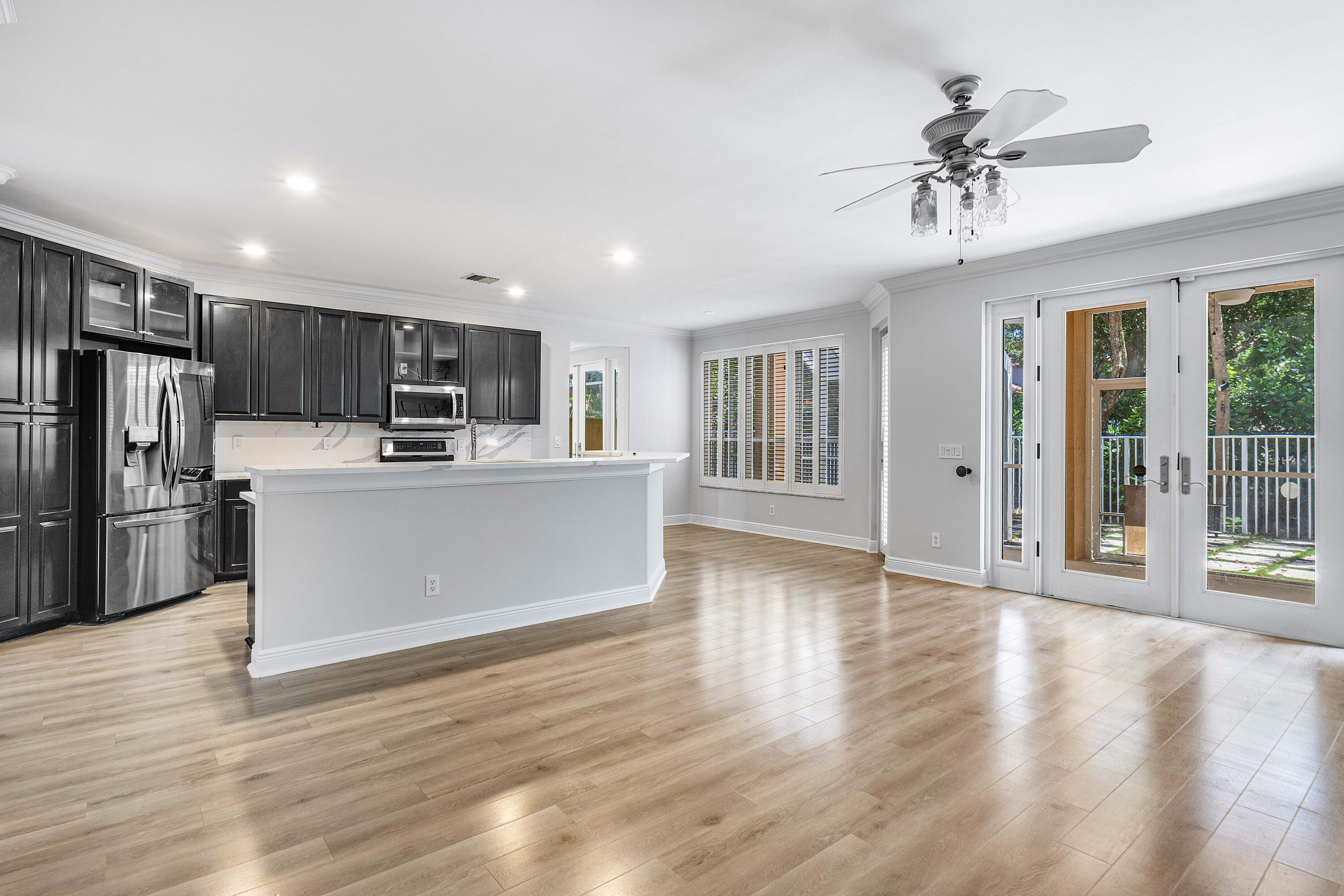 1655 East Classical Boulevard Delray Beach, FL 33445 - Photo 5 of 40 a view of kitchen with refrigerator stove and wooden floor