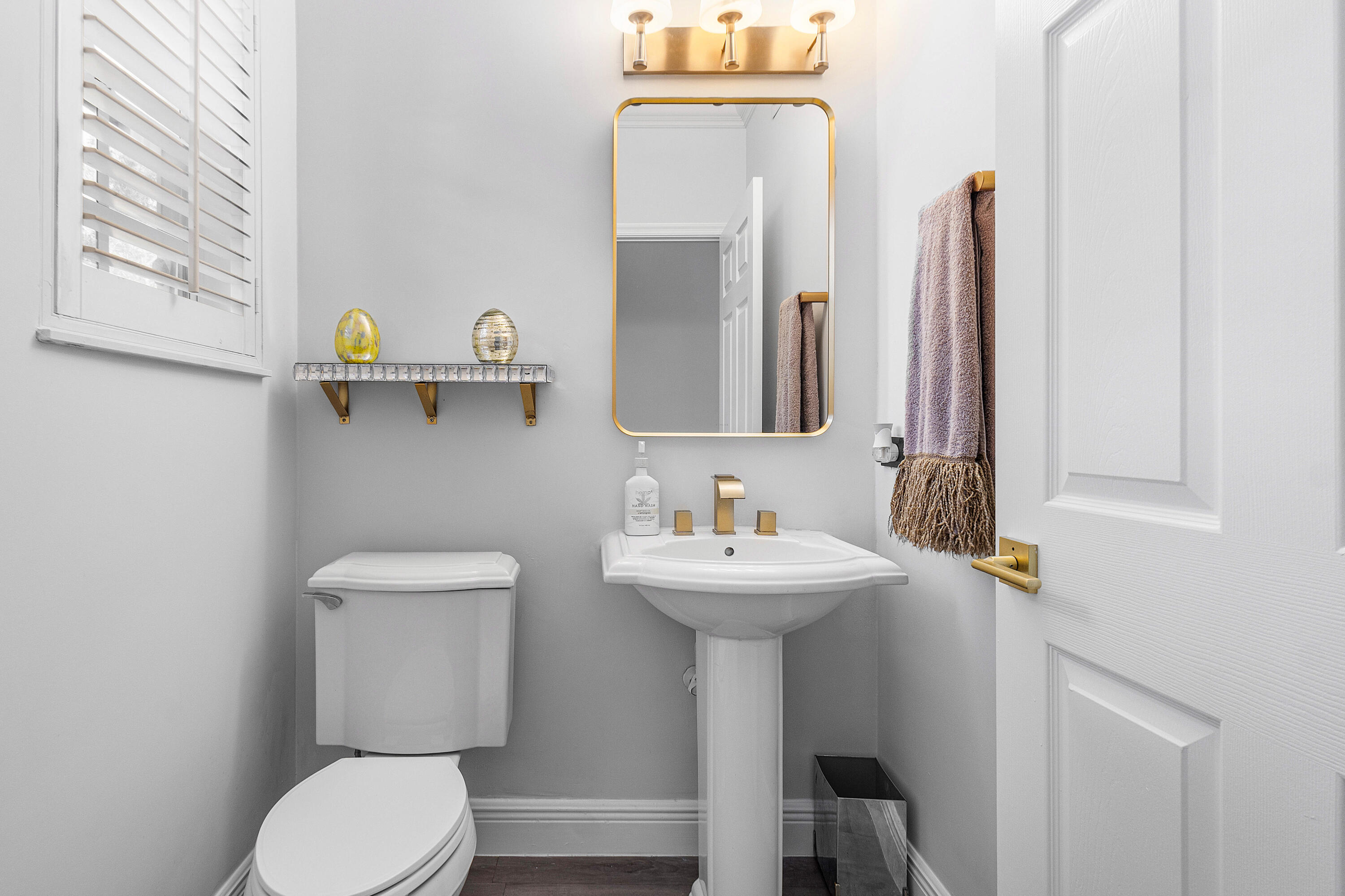 1655 East Classical Boulevard Delray Beach, FL 33445 - Photo 8 of 40 a bathroom with a toilet sink and mirror