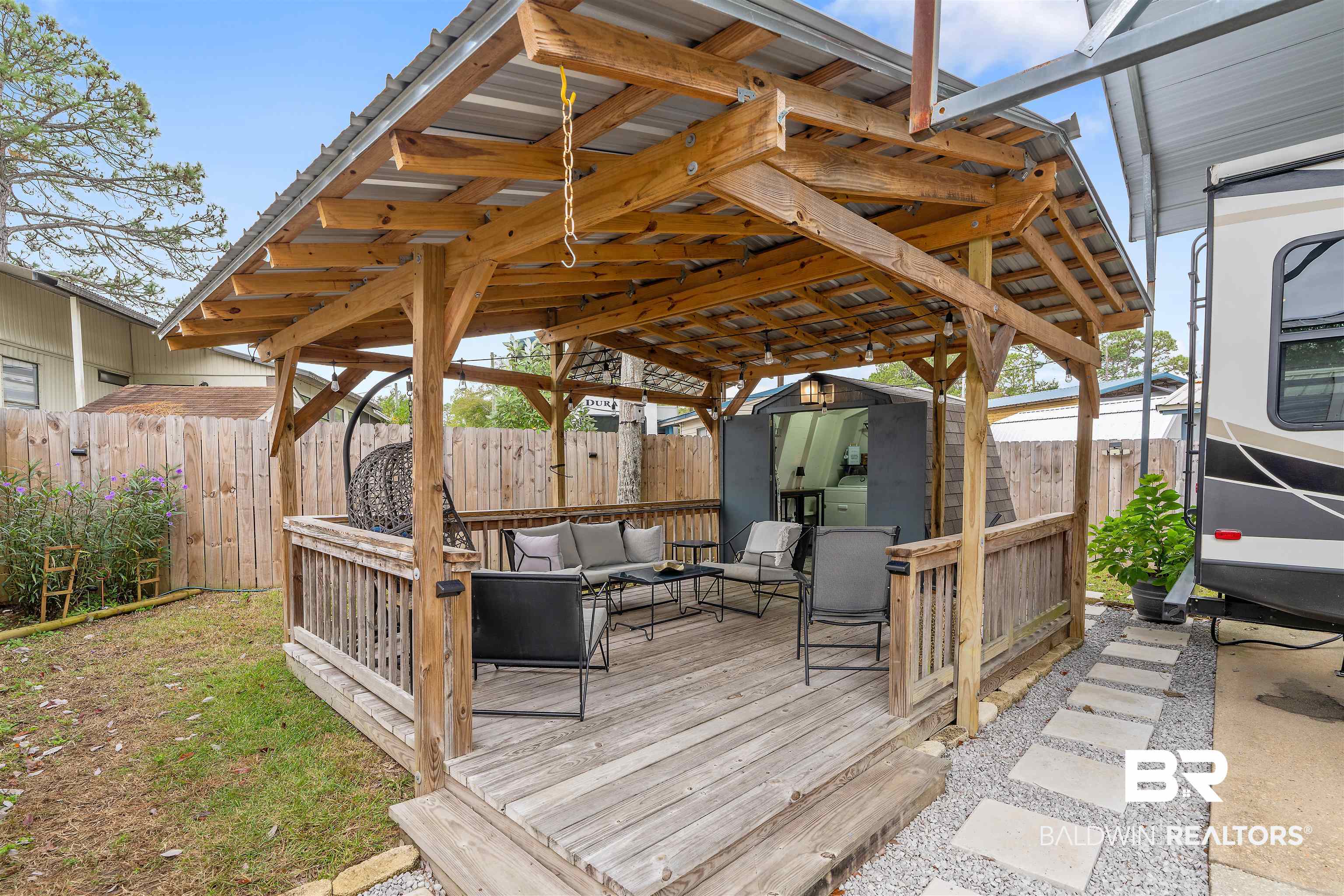 683 Escambia Loop Lillian, AL 36549 - Photo 15 of 27 Wooden terrace featuring outdoor lounge area and a storage shed