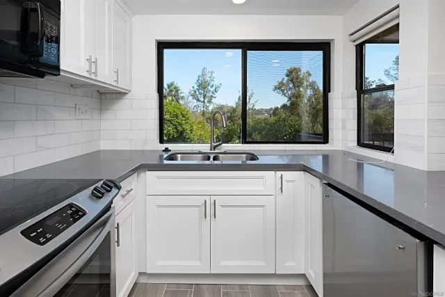 a view of a kitchen with a sink and a window