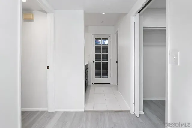 a view of hallway with wooden floor