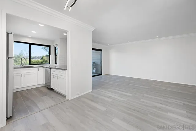 a view of a kitchen with a sink and a window