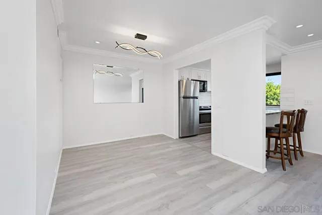a view of a livingroom with furniture and an empty room