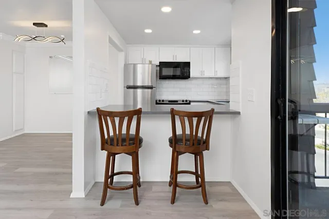 a view of kitchen with cabinets and outdoor space