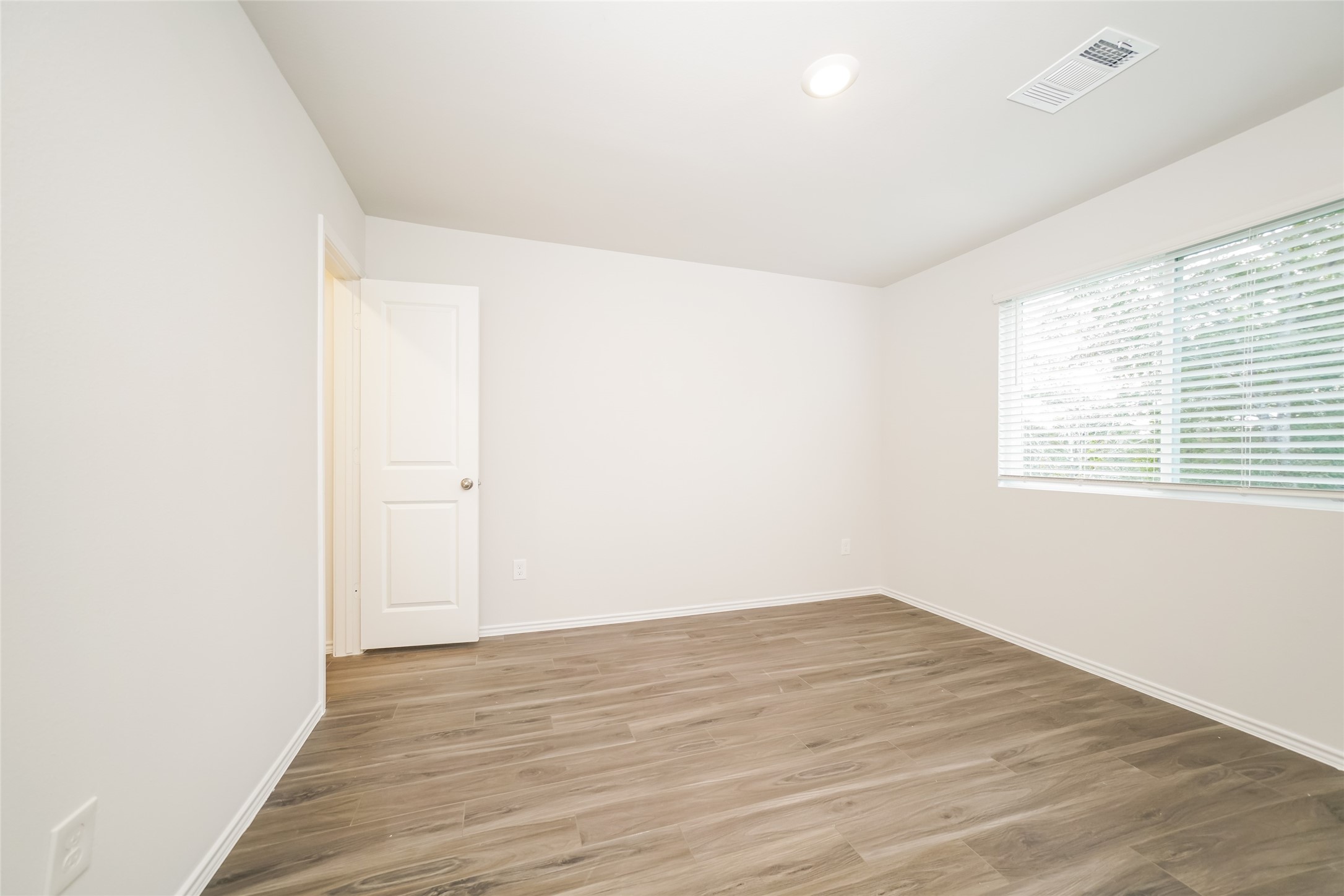 2161 Middle Rdg Drive Conroe, TX 77301 - Photo 11 of 20 an empty room with wooden floor and windows