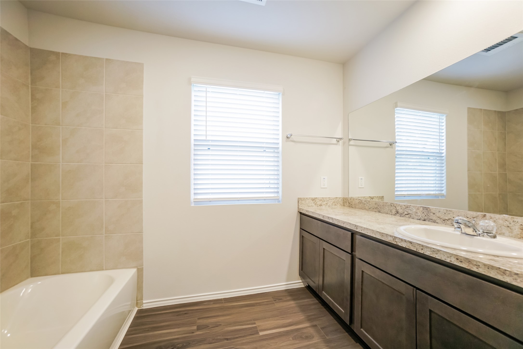 2161 Middle Rdg Drive Conroe, TX 77301 - Photo 12 of 20 a bathroom with a granite countertop sink and a bathtub