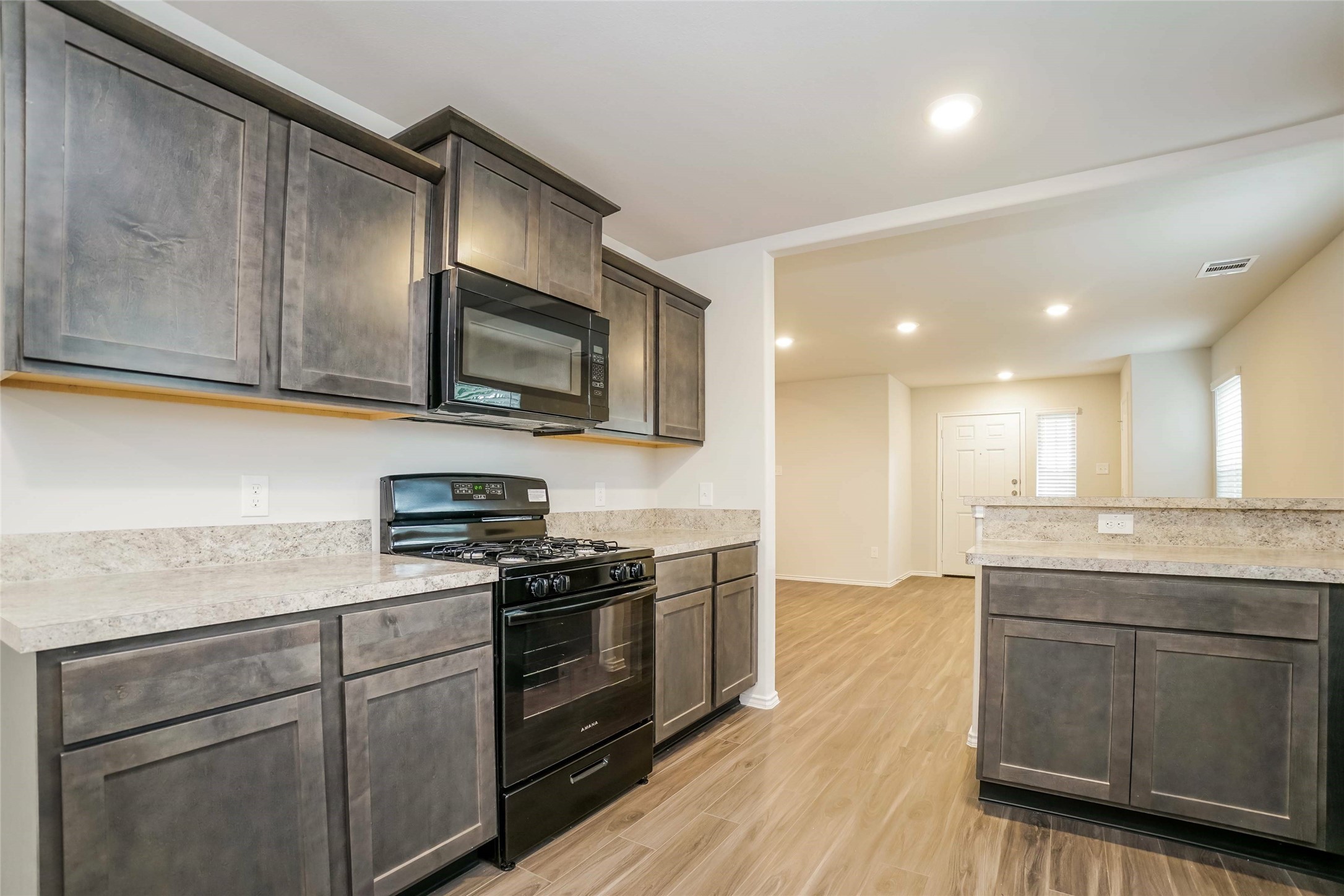 2161 Middle Rdg Drive Conroe, TX 77301 - Photo 4 of 20 a kitchen with stainless steel appliances granite countertop wooden cabinets granite counter tops and a hard wood floors