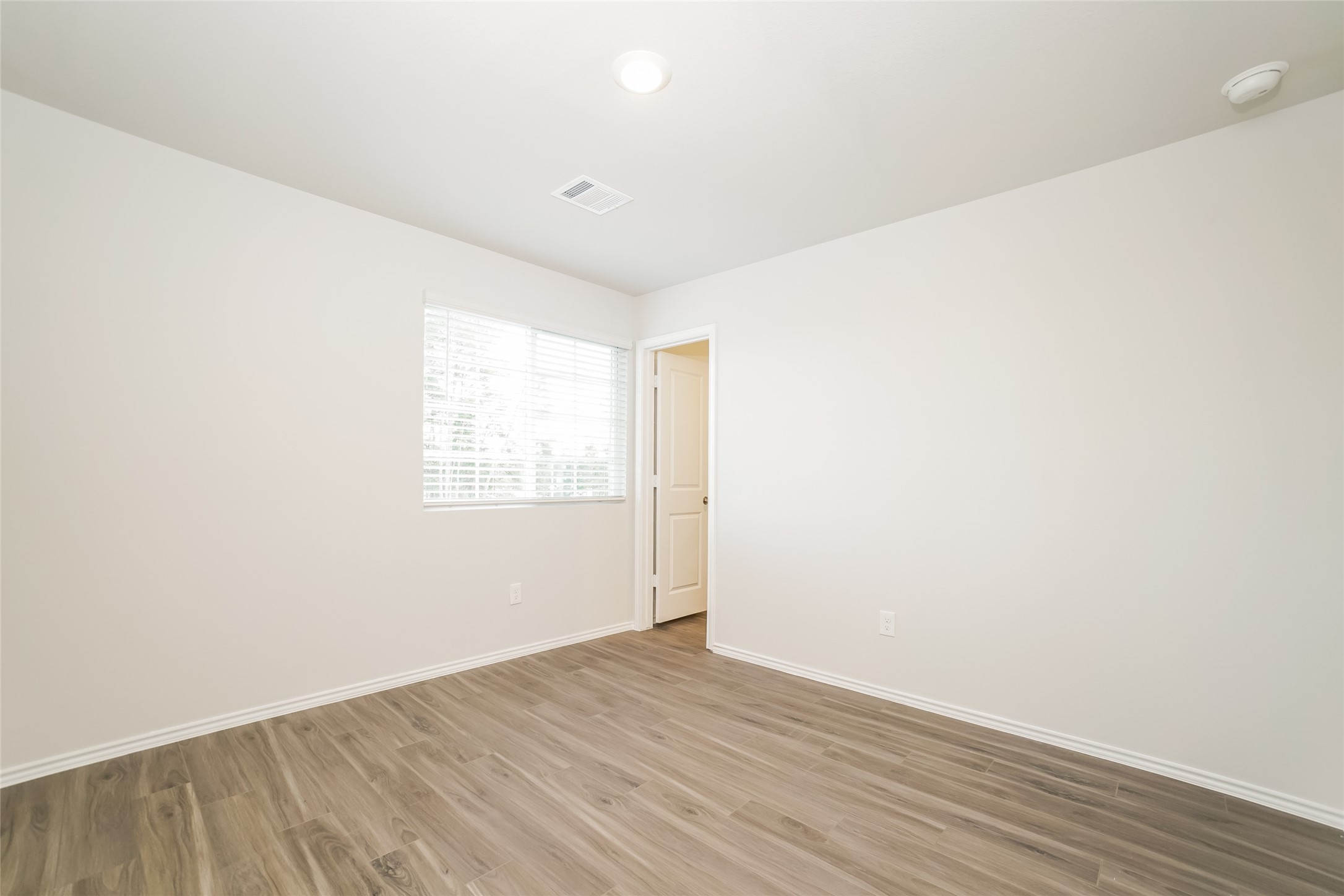 2161 Middle Rdg Drive Conroe, TX 77301 - Photo 10 of 20 a view of an empty room with wooden floor