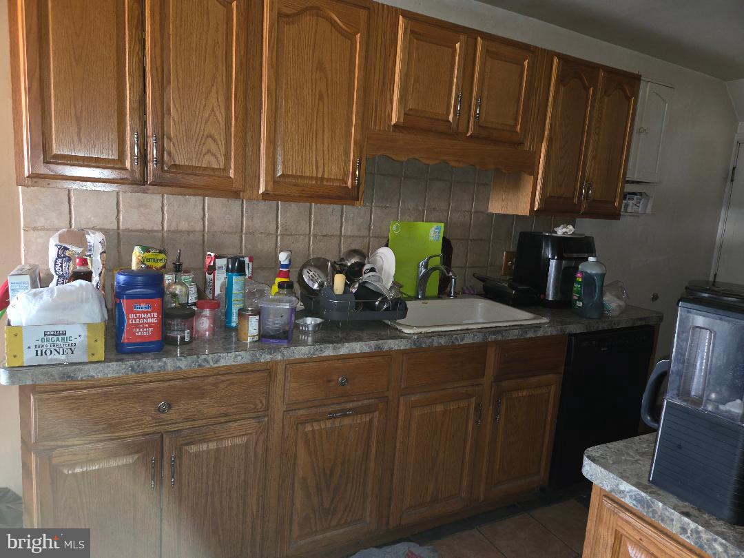 6340 Calvert Street Philadelphia, PA 19149 - Photo 4 of 14 a kitchen with stainless steel appliances granite countertop wooden cabinets a sink and dishwasher