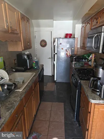 a kitchen with a sink stove and refrigerator