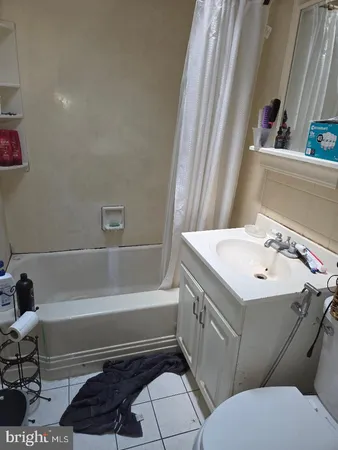 a bathroom with a sink a toilet and bathtub