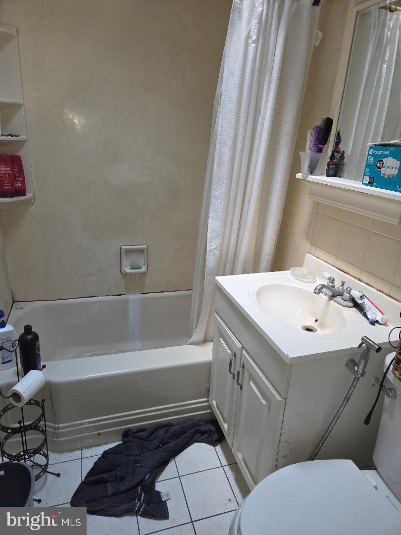 6340 Calvert Street Philadelphia, PA 19149 - Photo 9 of 14 a bathroom with a sink a toilet and bathtub