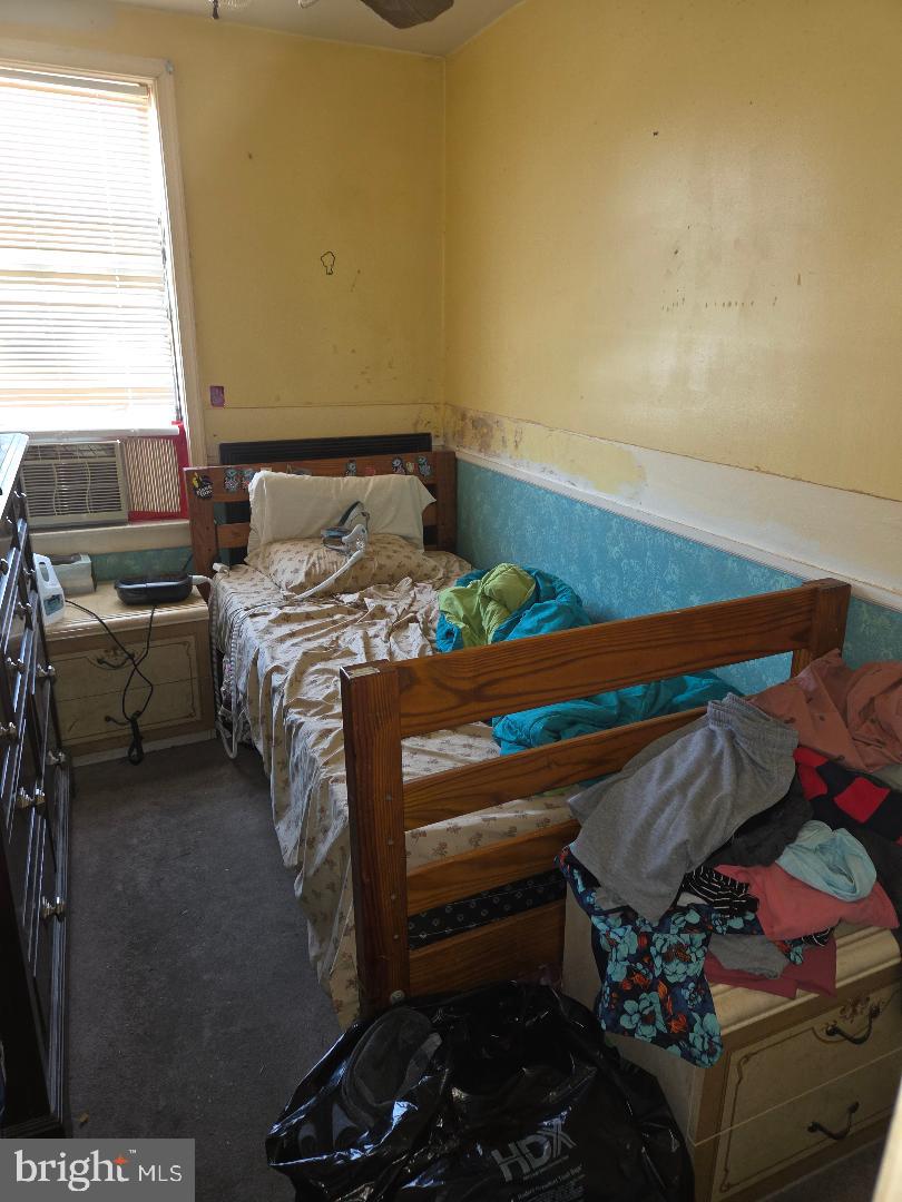 6340 Calvert Street Philadelphia, PA 19149 - Photo 10 of 14 a bed sitting in a bedroom next to a window