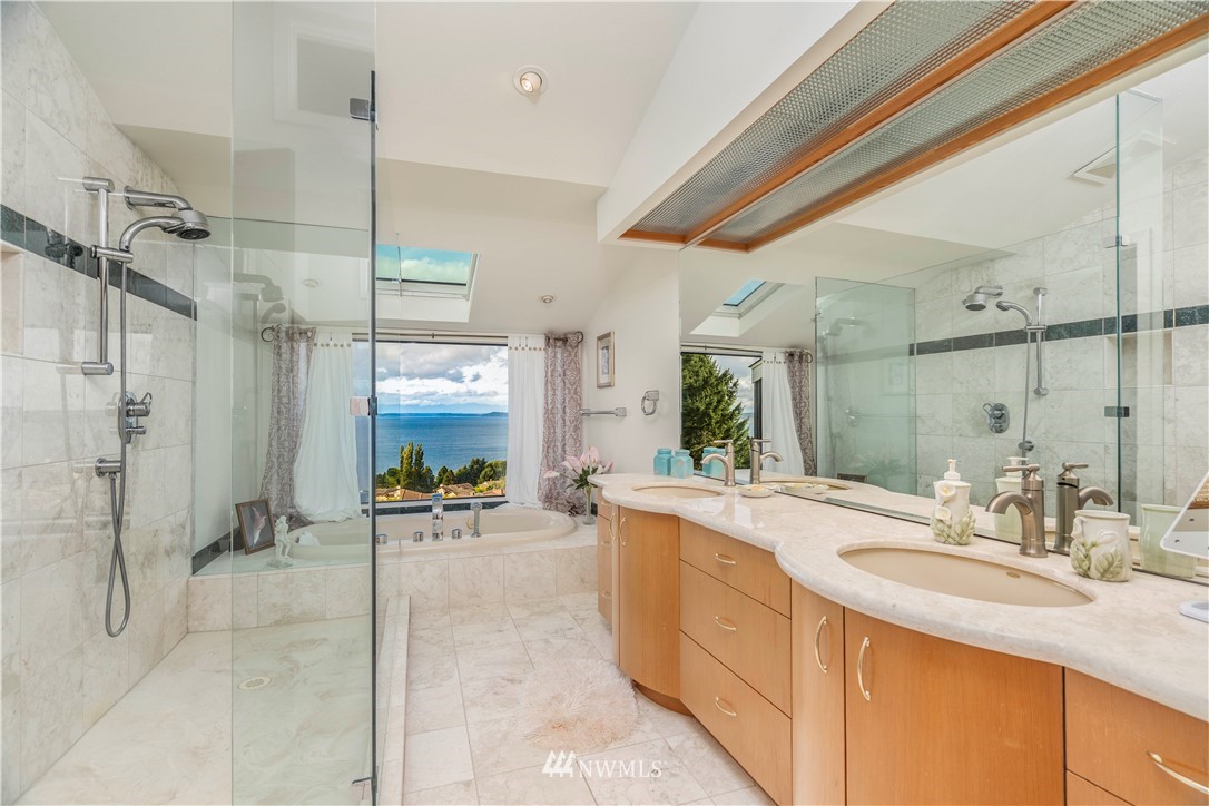 2604 Madrona Point Lane Steilacoom, WA 98388 - Photo 15 of 25 a large bathroom with a sink a large mirror and a shower