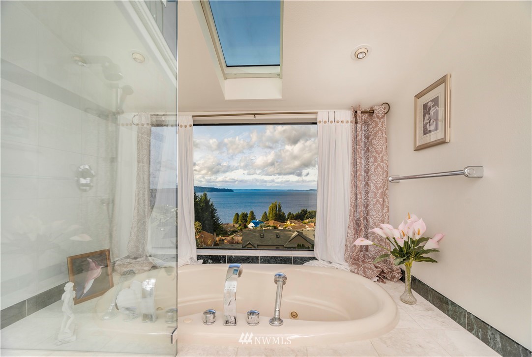2604 Madrona Point Lane Steilacoom, WA 98388 - Photo 16 of 25 a white bath tub sitting next to a bathroom sink